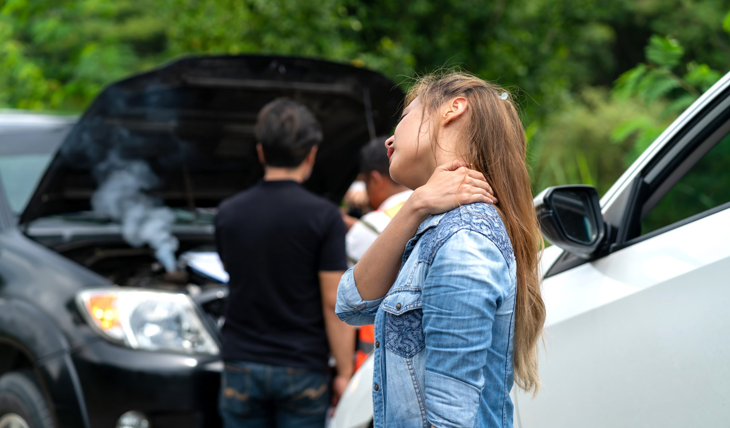 Woman experiencing neck pain after a car accident.
