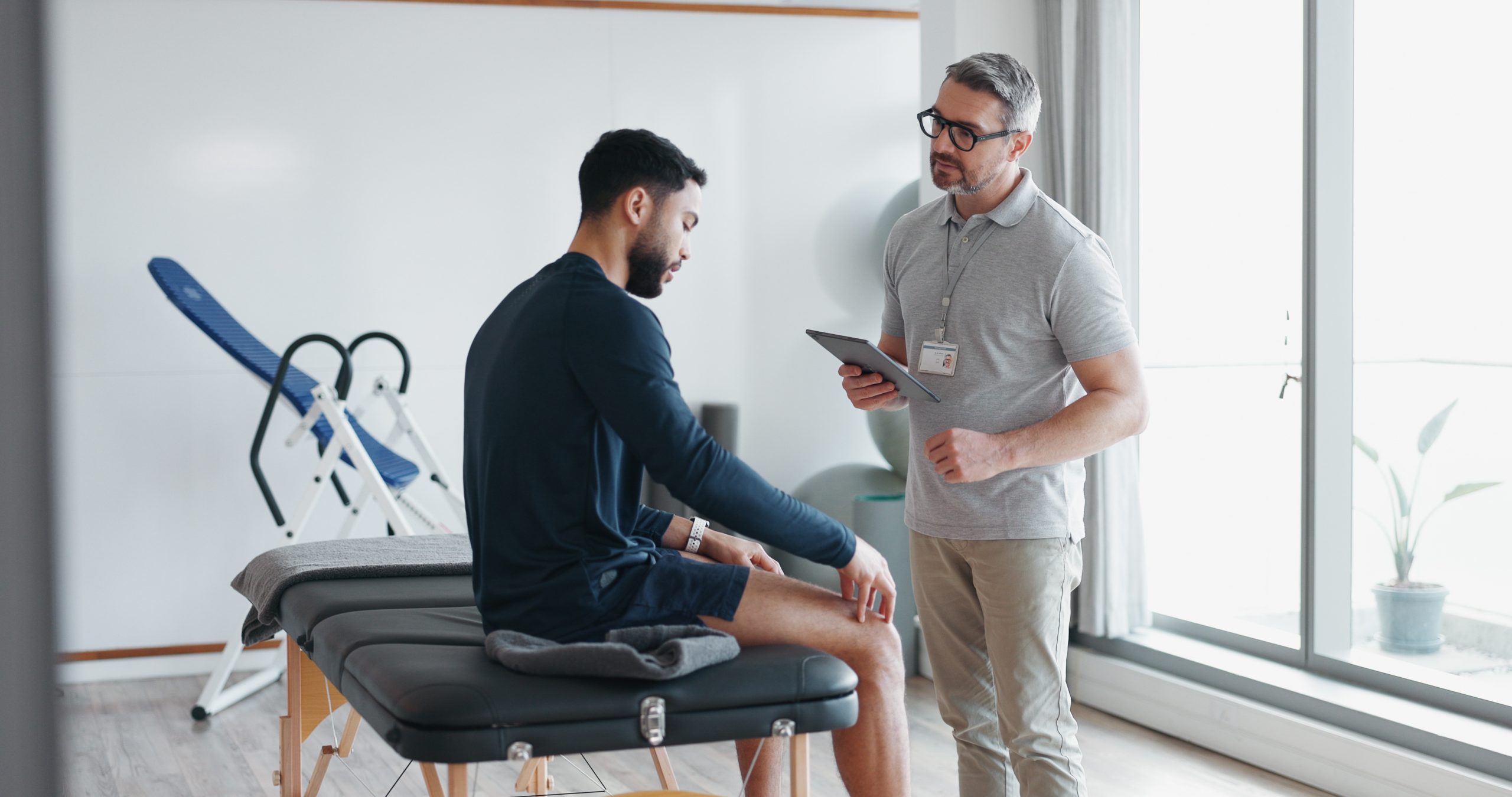 Chiropractor discussing a treatment plan with a patient in a clinic.